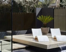 Load image into Gallery viewer, Angled view of the Ledge Lounger Signature Package with two white pool loungers
